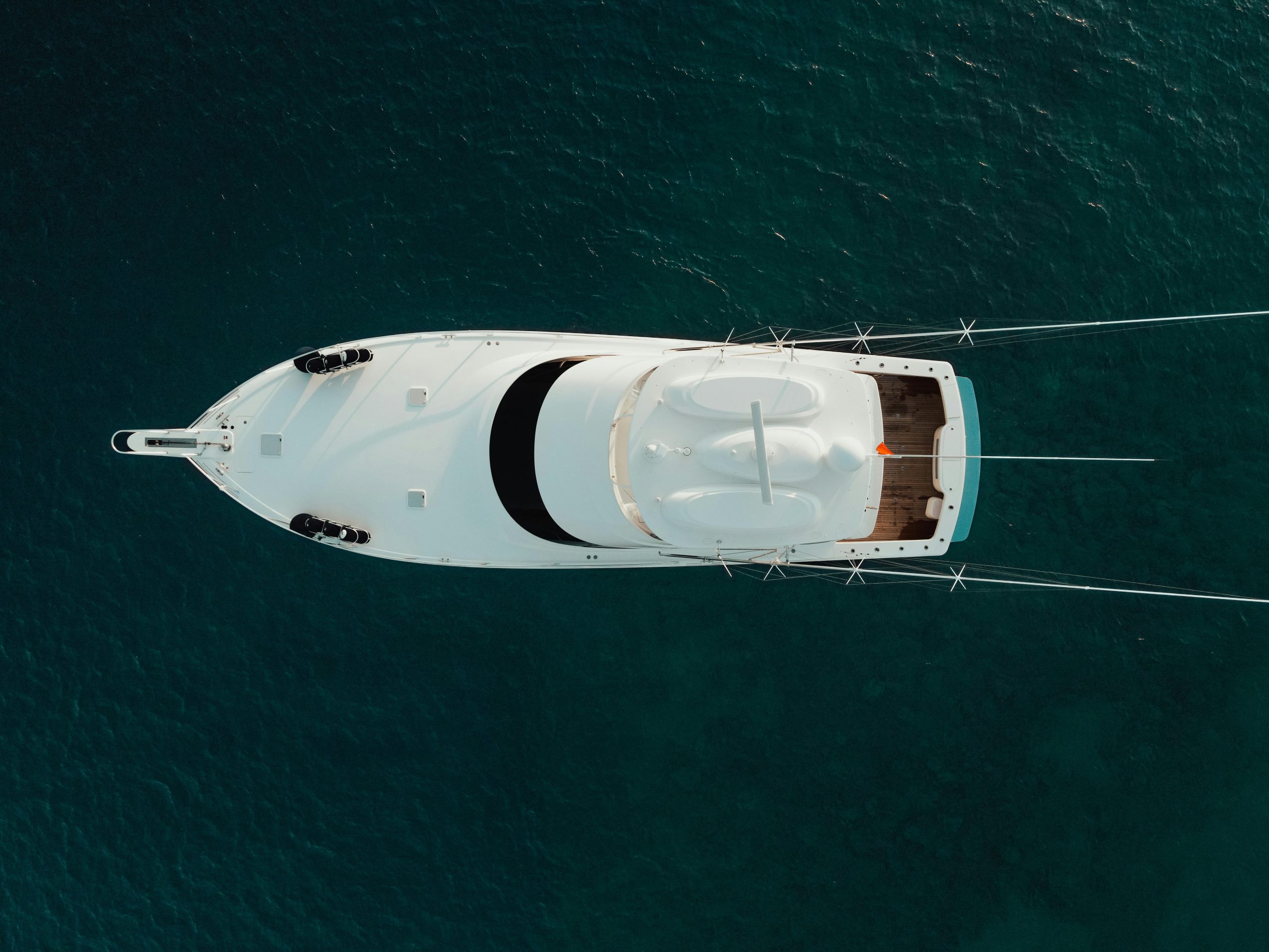 Top-down aerial shot of a luxury yacht cruising in Türkiye's stunning blue sea waters. Sell your boat, list your boat, orlando florida, central florida 